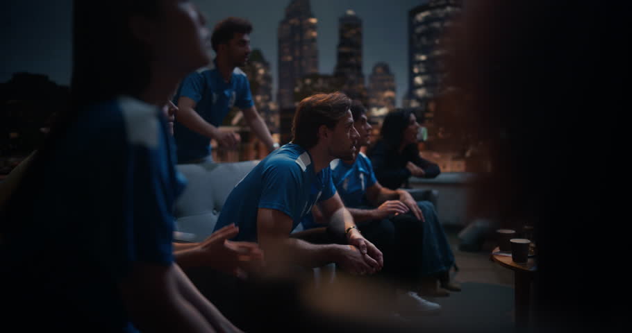 Friends Gather on a Rooftop to Watch a Championship Match. They Enjoy Sports and Entertainment Together, Cheering and Celebrating, Happy about Their Team Victory