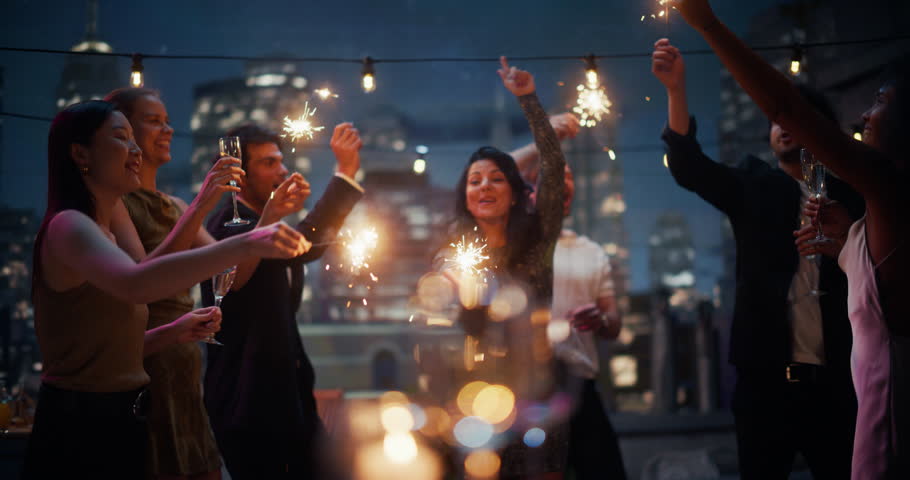 Elegant Rooftop Party With Beautiful Young People Celebrating New Years eve, Enjoying Cocktails and Music. Glamorous Model Dance, Have Fun with Sparles, Enjoy Luxurious of Nightlife