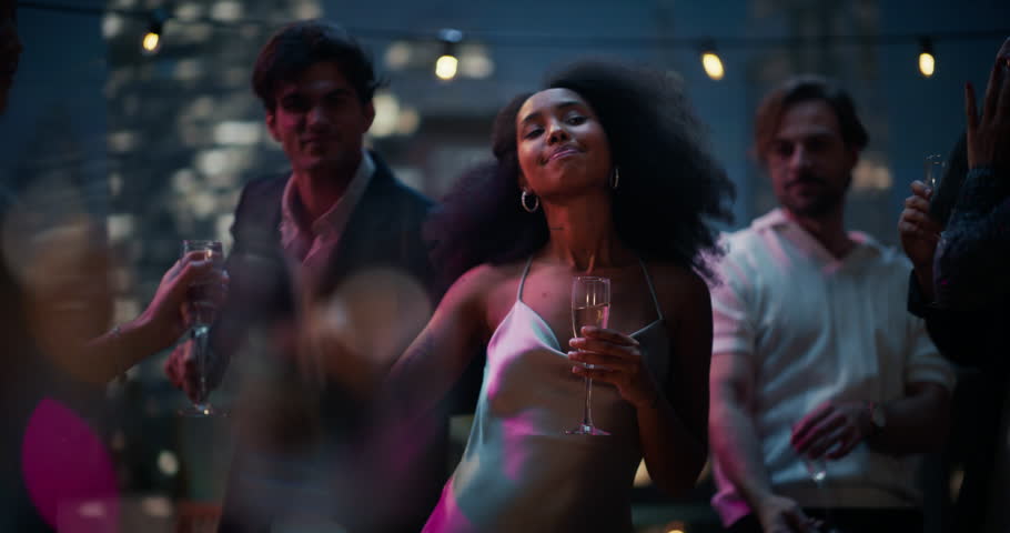 Glamorous Rooftop Cityview Party with Gorgeous Woman in a Cocktail Dress Dancing Charmingly in the Crowd. Exclusive Roof Outdoor Nightclub where Glamorous Young People Have Fun and Enjoy Life.