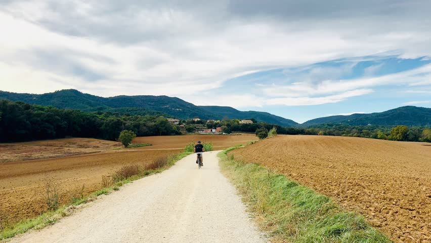 Man Walking along Rural Path with Mountains in Catalonia, Spain