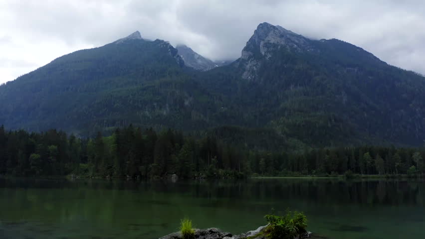 Aerial of relaxing landscape with mountains and a calm lake.