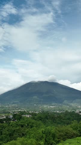 Vertical drone shot of mountain with sky
