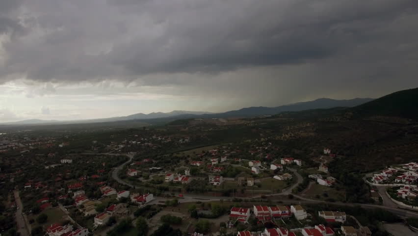 Aerial of a hilly landscape with houses.