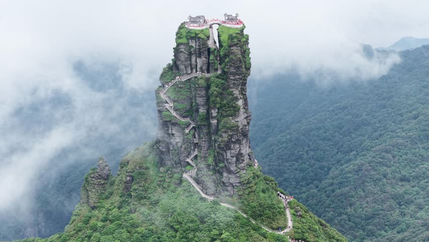 Aerial view of the majestic Fanjingshan mountain, a UNESCO World Heritage Site, with its winding staircase and temples at the summit, Fanjingshan, Guizhou, China.