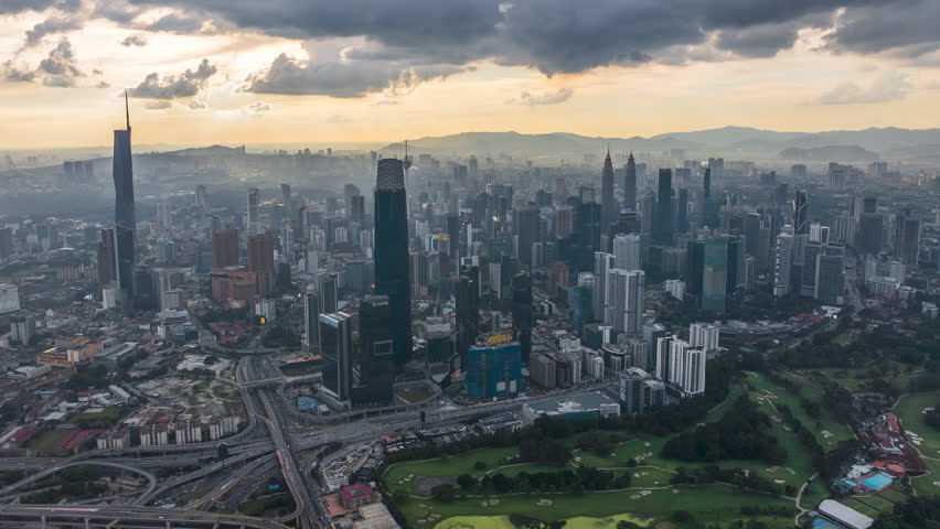 Cityscape Time lapse : Aerial Kuala Lumpur city view at golden evening overlooking the city skyline with beautiful ray of lights in Malaysia. Prores Full HD.