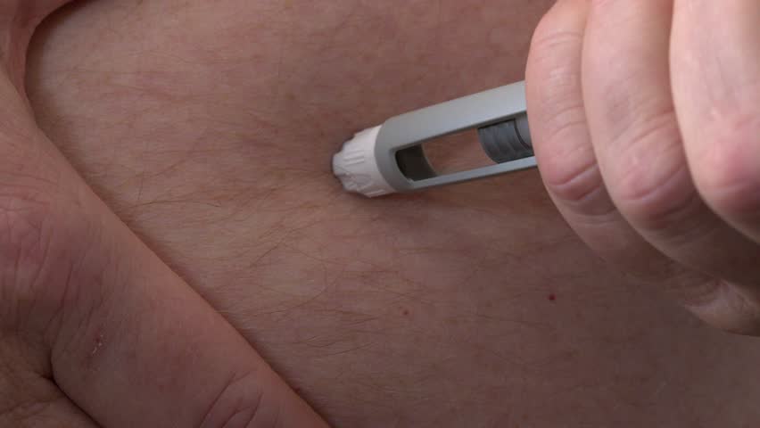 Clear semaglutide medication is injected into subcutaneous belly fat