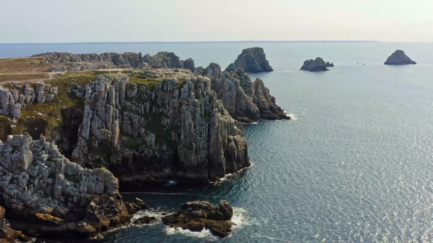 Aerial of scenic rocks along a sea.