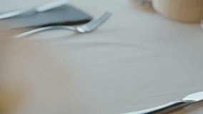 A waiter serves a plate of fresh salad with green leaves such as lettuce and arugula, cherry tomatoes, and other ingredients. - Powered by Shutterstock - Get 15% off with code: PIKWIZARD15