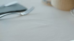 A waiter serves a plate of fresh salad with green leaves such as lettuce and arugula, cherry tomatoes, and other ingredients. - Powered by Shutterstock - Get 15% off with code: PIKWIZARD15