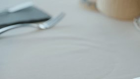 A waiter serves a plate of fresh salad with green leaves such as lettuce and arugula, cherry tomatoes, and other ingredients. - Powered by Shutterstock - Get 15% off with code: PIKWIZARD15