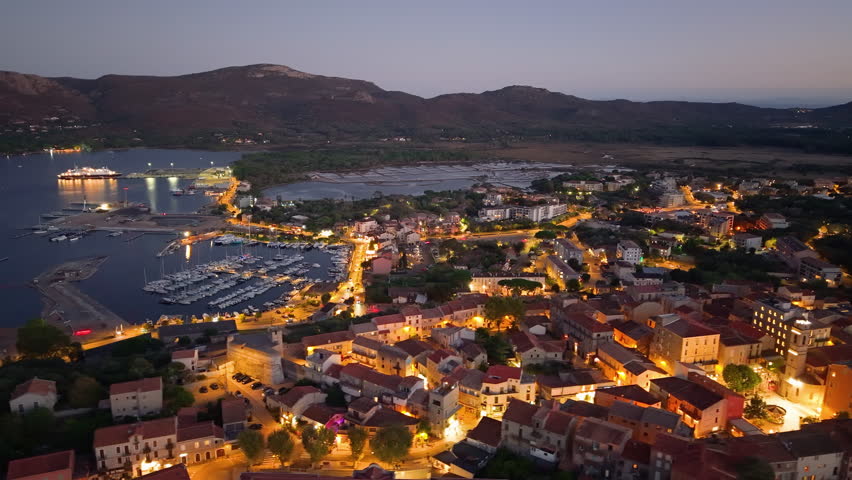 scenic aerial perspective of calm coastal town featuring bright rooftops and gentle bay waters. Porto-Vecchio. France