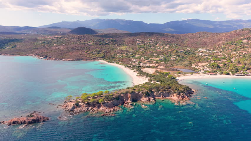 sunny corsican scenic panorama, serene turquoise waters with lush pinecovered headlands visible. France