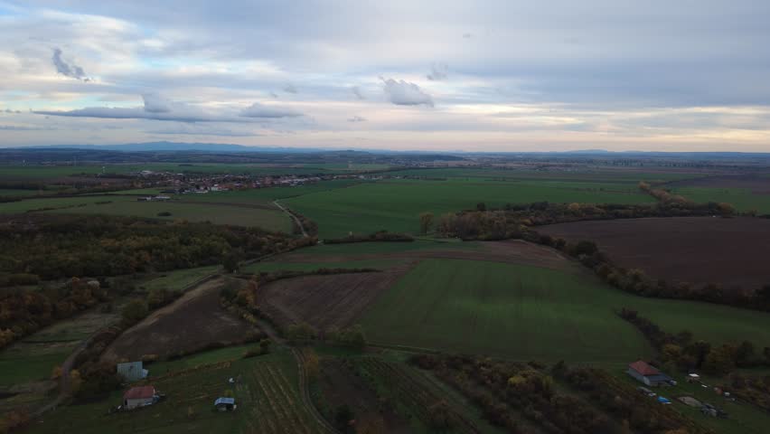 Aerial view on countrysidein Slovakia and green field and red and blue sky 