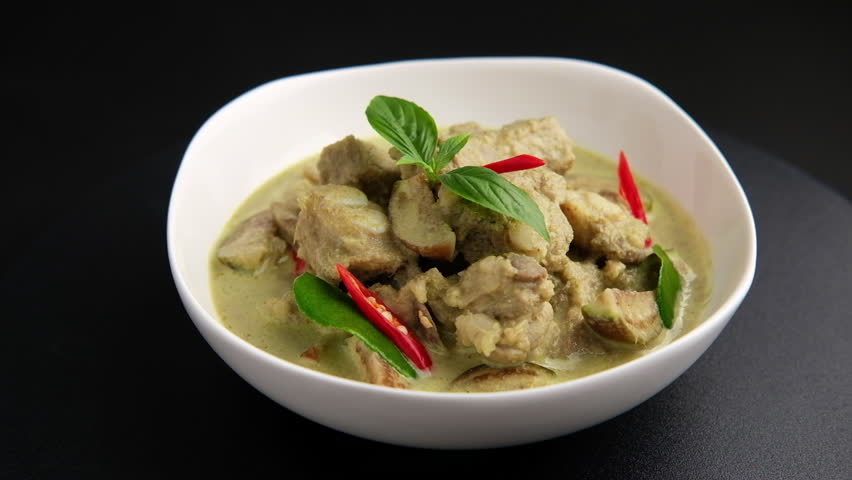 Thai Green Curry with baby pork ribs (pork cartilage) and Thai Eggplant in white bowl ,thai food ,Gaeng Kiew Wan