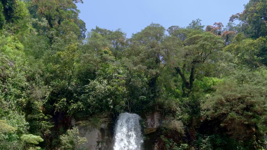 Waterfall cascading in tropical mountain forest
