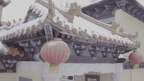 Red Chinese Lanterns Hanging from Pagoda Roofs