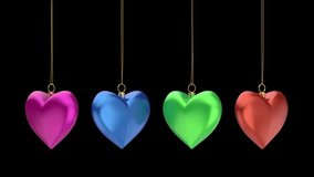 Spinning four different colored heart-shaped Christmas ornaments on black background - Powered by Shutterstock - Get 15% off with code: PIKWIZARD15