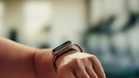 Smart watch using in gym, Close up of woman hands im gym checking incoming notification on smart watch. Incoming text message received on app smartwatch. Social media networking technology concept. - Powered by Shutterstock - Get 15% off with code: PIKWIZARD15