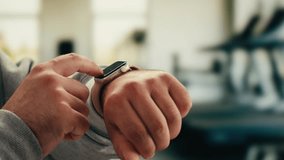 Smart watch using in gym, Close up of woman hands im gym checking incoming notification on smart watch. Incoming text message received on app smartwatch. Social media networking technology concept. - Powered by Shutterstock - Get 15% off with code: PIKWIZARD15