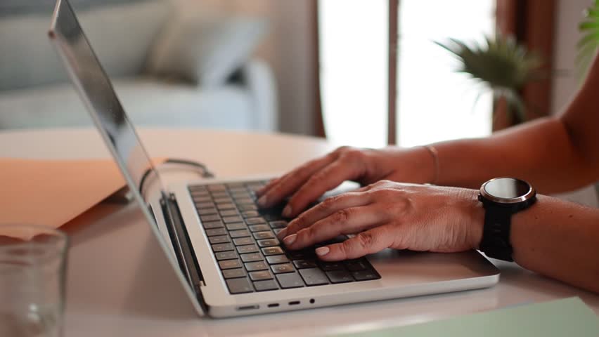 Woman typing on laptop working from home