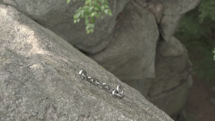 Chain to facilitate the difficult passage hiking trail in the mountains, permanently attached to the rock