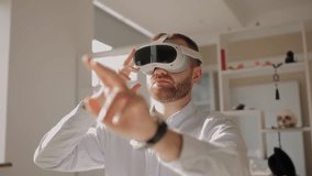 Young caucasian male engaging with virtual reality in bright indoor setting office. New experience for online video call and working. - Powered by Shutterstock - Get 15% off with code: PIKWIZARD15