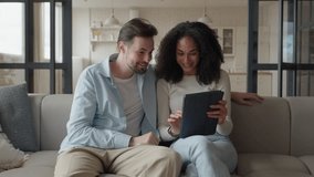 Couple Discussing Tablet Content Together On Cozy Living Room Sofa - Powered by Shutterstock - Get 15% off with code: PIKWIZARD15