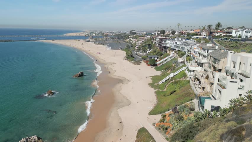 Drone footage of Newport Beach ocean coastline aerial view with scenic horizon and sandy beach in Orange County California USA