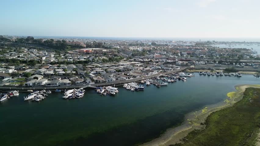 Drone aerial footage of Costa Mesa coastline in Orange County California USA sandy beach ocean water and horizon seascape background