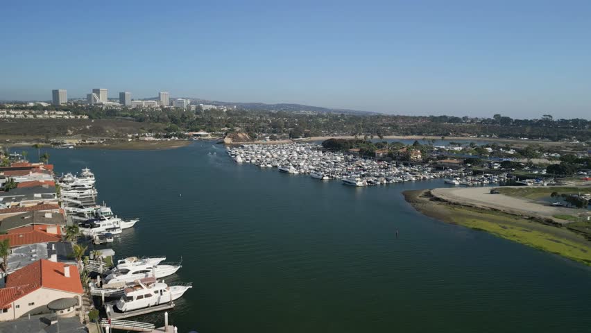 Aerial drone shot of Costa Mesa California coastline with oceanfront sandy beach and scenic sky in Orange County USA travel concept