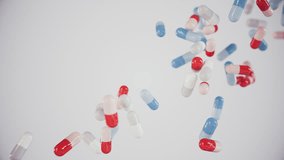 Medical pills and capsules in red, white, and blue color fall in slow motion. Ultra HD 4K 3840x2160 animation for healthcare, pharmaceutical, and science-related topics. - Powered by Shutterstock - Get 15% off with code: PIKWIZARD15