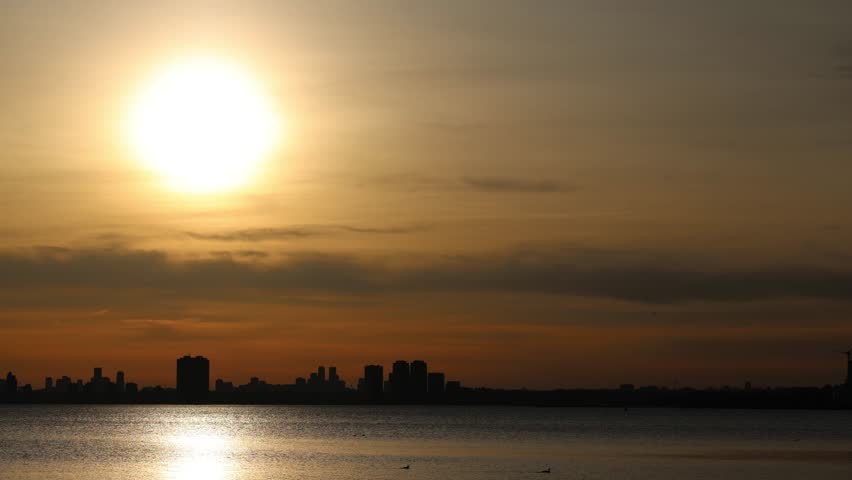 Time-lapse footage of sunset light over the Toronto Islands waterfront. Recorded in Toronto, Ontario, Canada.