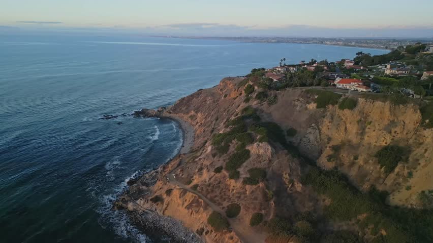 Beautiful cinematic aerial panorama of Torrance California beach coastline with oceanfront horizon in Los Angeles County USA summer travel footage