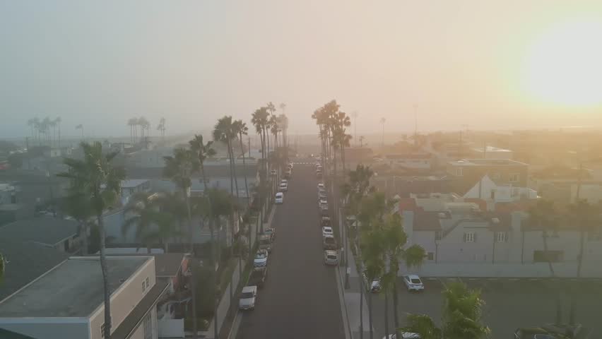 Drone aerial view of Seal Beach California coastline with ocean waves rolling onto sandy beach in Orange County USA seascape background