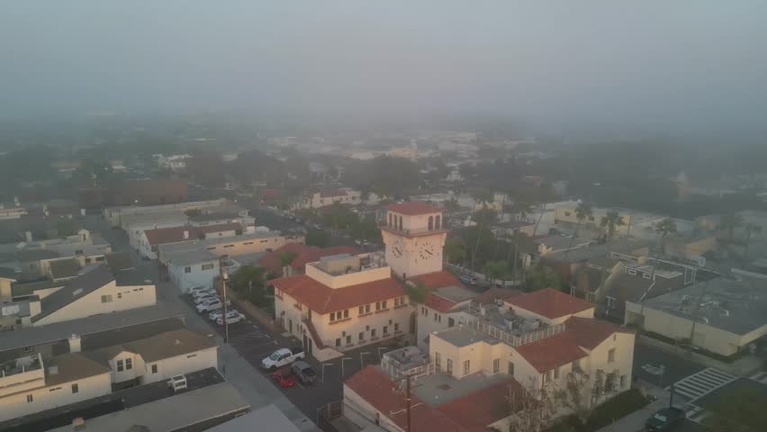 Wide drone aerial shot of Seal Beach California sandy shoreline with ocean horizon and clear sky in Orange County USA coastal travel background