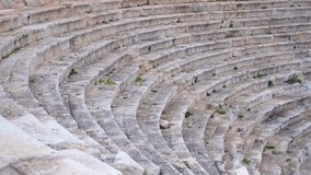 Ancient stone steps of amphitheater sweeping pan. Smooth camera movement showcasing the weathered stone steps of the ancient amphitheater, revealing its historical grandeur and architectural design - Powered by Shutterstock - Get 15% off with code: PIKWIZARD15