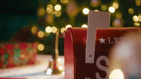 Santa Claus's Hand With Glove Opens Mailbox To Read Christmas Wishes - Powered by Shutterstock - Get 15% off with code: PIKWIZARD15