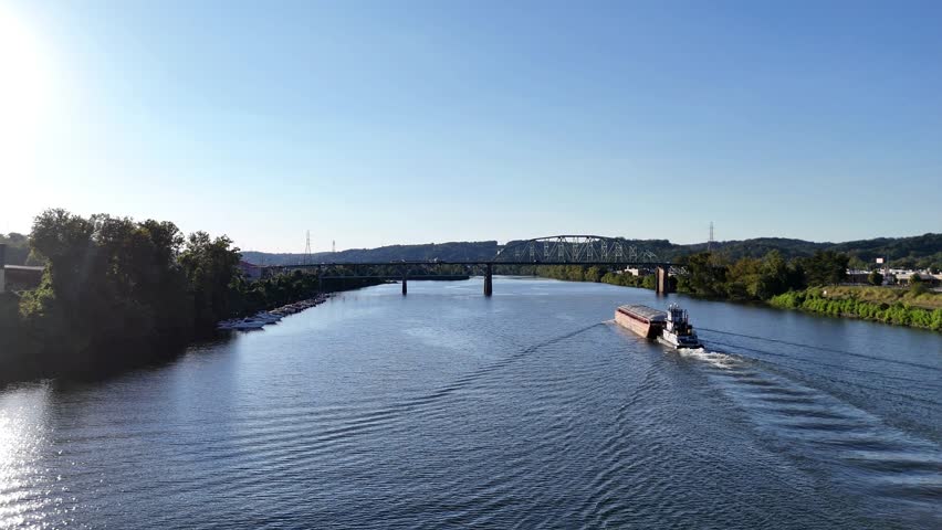 South Charleston City Skyline Over Kanawha River With Patrick Street Bridge with River Barge On Wide Waterway