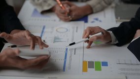 Colleagues discussing and analyzing financial reports with charts and graphs during a meeting - Powered by Shutterstock - Get 15% off with code: PIKWIZARD15