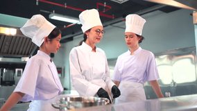 Group of culinary students and professional chefs in white uniforms and hats in a modern cooking school kitchen. Learning cooking, frying, cook a spaghetti in professional kitchen with instructor. - Powered by Shutterstock - Get 15% off with code: PIKWIZARD15