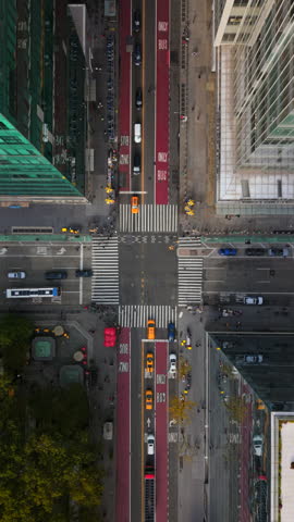 Incredible Top Down Bird View of New York City Manhattan intersection, car and yellow taxi stopping on the red light, pedestrians crossing, Aerial shot shows beauty of New York City, New York State