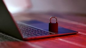 Locked padlock on laptop keyboard with warning message on screen about danger of vulnerable system in cybercrime and hacker attack concept. - Powered by Shutterstock - Get 15% off with code: PIKWIZARD15