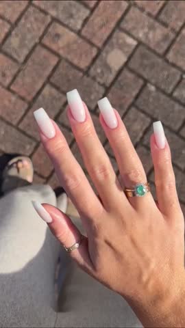 Elegant young woman showing her freshly manicured hands with modern stylish nail art and smooth soft skin