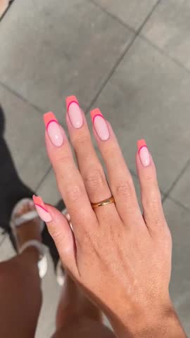 Elegant young woman showing her freshly manicured hands with modern stylish nail art and smooth soft skin