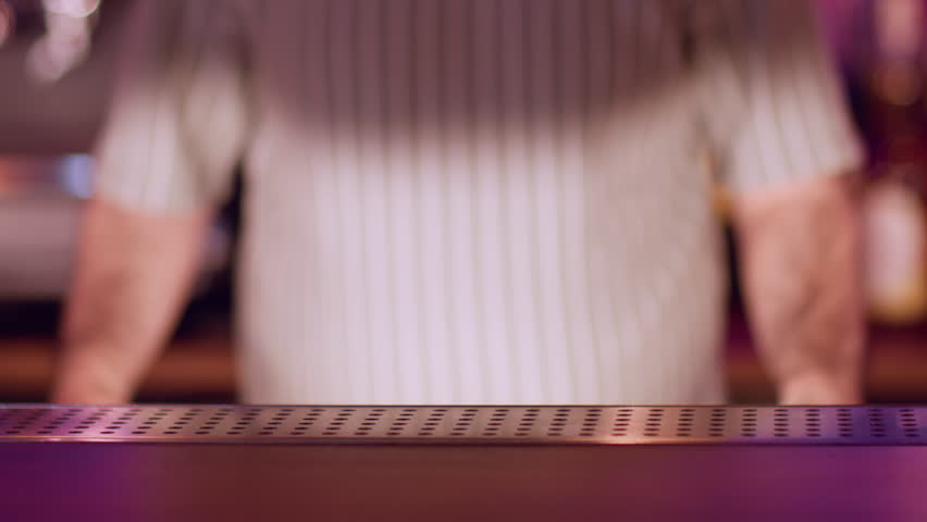 Barman work. Serving alcoholic drink. Barkeeper putting on counter little empty clay bowls for traditional asian beverage. Ceramic dishes rice wine.