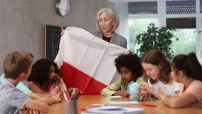 listening to teacher s story about Poland, child examines this country on globe. High quality 4k footage - Powered by Shutterstock - Get 15% off with code: PIKWIZARD15
