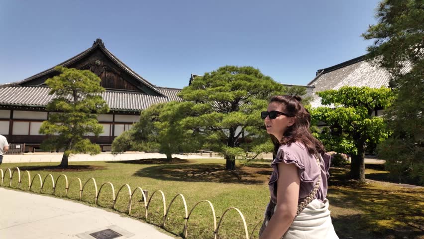 Woman walking inside Nijo Castle Japanese garden ground Ninomaru Palace