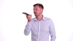 A businessman interacts with his phone using voice command technology, showcasing modern communication. - Powered by Shutterstock - Get 15% off with code: PIKWIZARD15