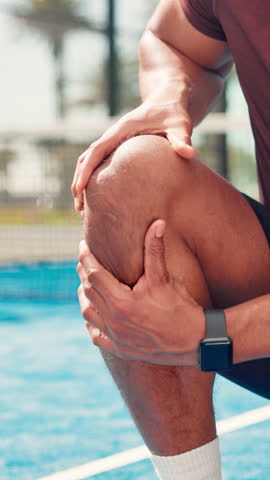 Hands, knee pain and man on tennis court with injury, joint inflammation or training accident. Sports, health and padel player with sore leg, strain or athlete with muscle tension for outdoor game