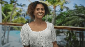 Woman smiling presenting open palm, points finger to palm in studio resort pool scene; warm welcome joy. - Powered by Shutterstock - Get 15% off with code: PIKWIZARD15